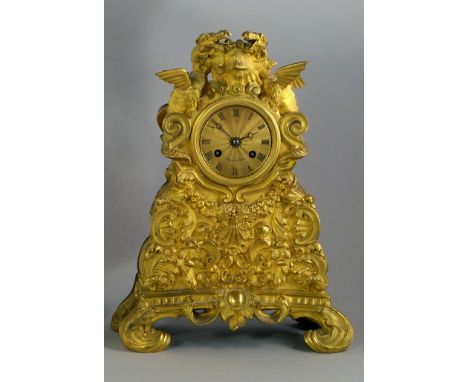 A French ormolu mantle clock, late 19th century, surmounted with a pair of dragons enclosing gilt metal face with Roman Numer