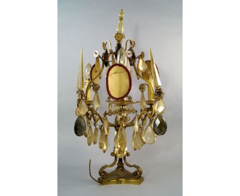 A three light brass and lustre hung candelabra, 20th century, the shaped brass frame on scrolling feet, with trefoil base, 67