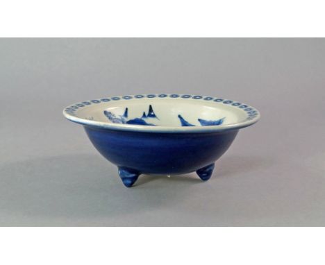 A Chinese blue and white porcelain bowl, 19th century, on tripod feet,  painted to the interior with a landscape of mountains
