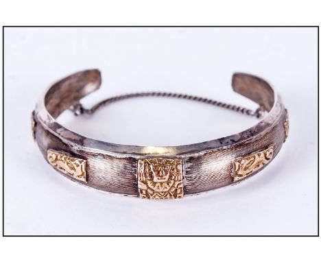 South American Silver & 18ct Gold Bangle, the silver overlaid with 18ct Gold Aztec style decoration. Marked 18ct & 925. Small