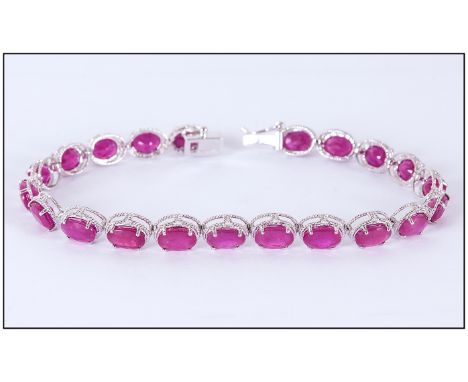 Ruby Oval Cut Tennis Bracelet, 25cts of rich red rubies, oval cut and set in narrow rhodium and silver millegrain frames, in 