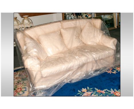 Tretrad Three Seater Sofa covered in a cream floral fabric, with loose cushion back & seats. Four loose cushions & arm covers