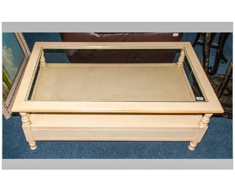 Modern Cream Coloured Coffee Table with Glass Top and Shelf Below. 47 x 27 Inches. 