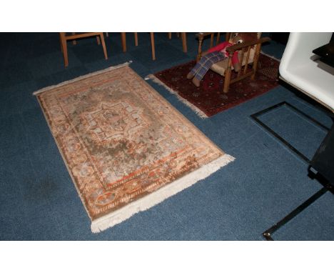 Two Oriental Carpets, one of Bokara type on a ruby red ground. 36x60'' geometric design carpet in pastel colours, 42x60''