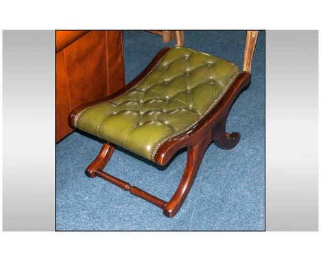 A Green Button Back Leather Saddle Back Stool, In Mahogany, On Shaped Legs with Cross Stretcher. 