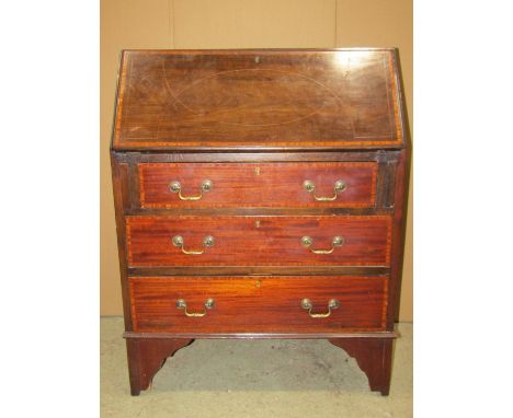 An inlaid Edwardian mahogany writing bureau with satinwood crossbanding and boxwood stringing, the fall flap enclosing a simp