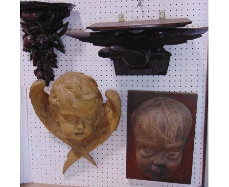A 19th century carved mahogany wall bracket in the form of trailing fruit, a further eagle with outstretched wings, and two f