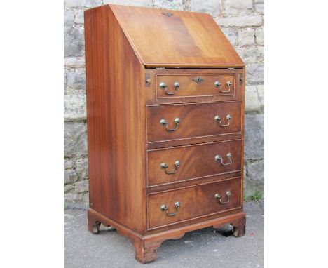 A small reproduction Georgian style mahogany ladies writing bureau, the fall flap enclosing an interior of two small drawers,
