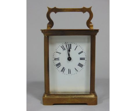 Brass carriage clock with serpentine handle and open jewelled escapement within a morocco leather carry case (case af) 