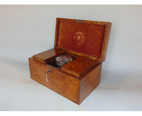 A good quality 19th century figured oak tea caddy of rectangular form, the central cut glass vessel with mushroom shaped stop