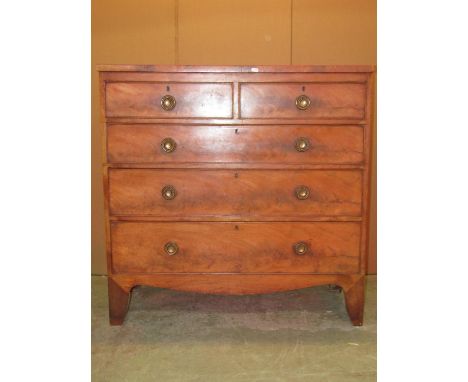 A 19th century mahogany bedroom chest of two short over three long graduated drawers with circular ring handles, over a shape