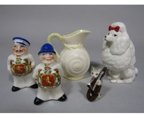 A Beswick model of a white poodle with red bow, a Beswick model of cat playing a fiddle, a Belleek jug modelled as a shell an