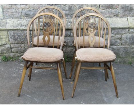 A set of four stained elm and beechwood hoop and stick back dining chairs (probably Ercol) with pierced splats and splay supp