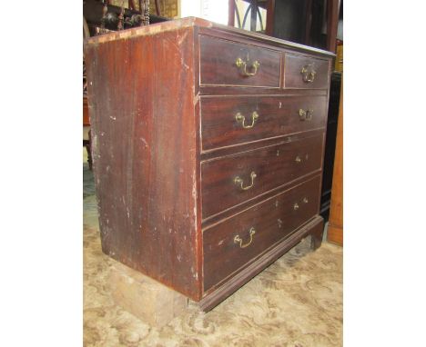 A Georgian mahogany bedroom chest of two short over three long graduated drawers with brass swan neck handles and raised on b