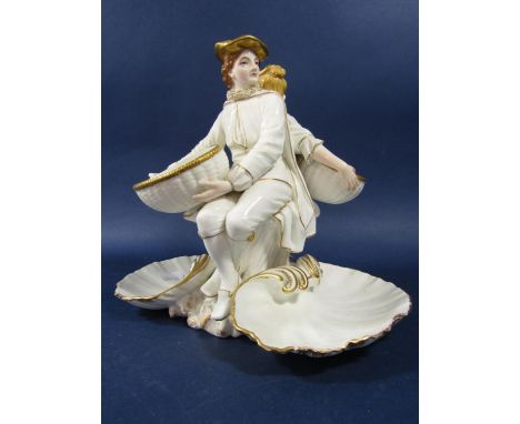 A 19th century Worcester sweet meat dish modelled as a pair of Watteauesque style characters supporting baskets and with gree