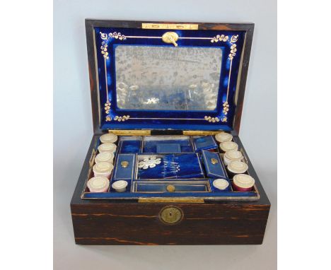 A mid Victorian coromandel wood ladies sewing box with comprehensively fitted interior, with mother of pearl spools, winders,