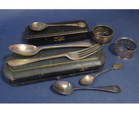 A mixed collection of silver comprising two napkin rings, a child's bangle, two spoons, a cased further spoon and a cased for