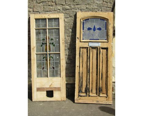 A reclaimed partially stripped hardwood front door, enclosing an arched leaded light panel and three slender fielded panels, 