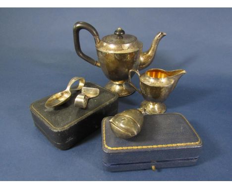 A small teapot and milk jug, silver teething bell (incomplete) a silver babies spoon and food pusher (4) 10.5oz approx total 