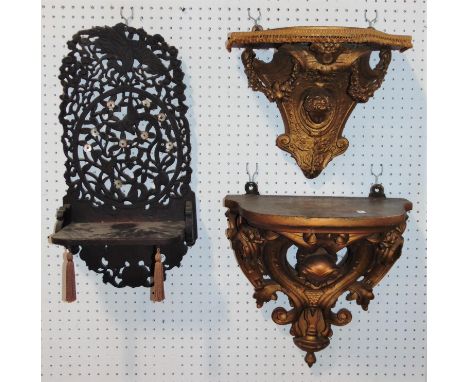 19th century gilded wall bracket, with shaped and pierced detail incorporating a female head, a further similar smaller examp