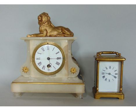 A simple brass carriage clock with eight day movement and a 19th century alabaster cased clock with eight day time piece surm