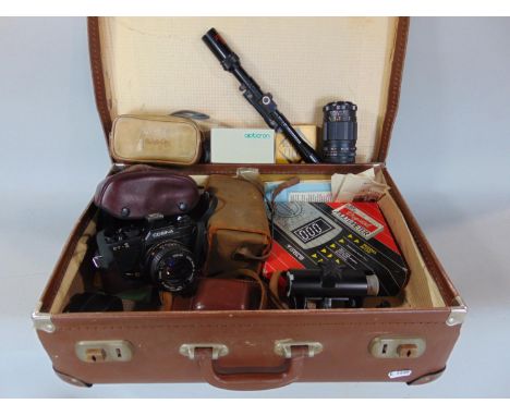 A suitcase containing a miscellaneous collection of vintage camera equipment including a Wirgin Dixa camera, a Cosina CT1 and