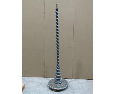 An Edwardian/1920s wooden standard lamp with spiral twist column and moulded disc shaped base, and all over green painted and