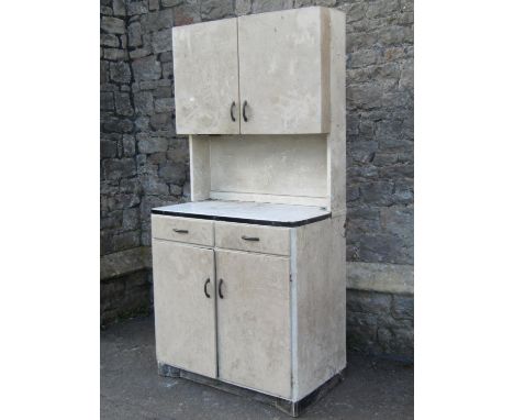 A vintage wooden freestanding kitchen cabinet enclosed by an arrangement of four doors and two frieze drawers beneath an enam