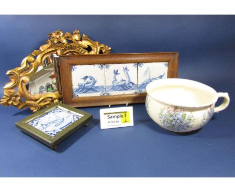 A set of three early 19th century Delft type blue and white tiles with painted fish and sea monster detail in oak frame, toge
