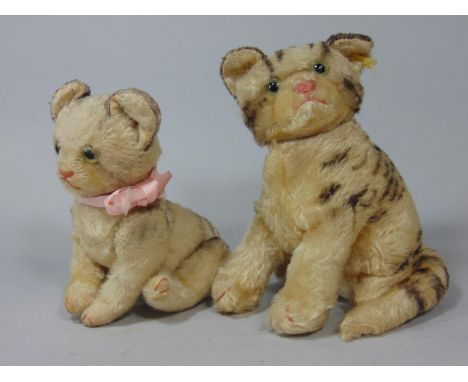 Vintage sitting tabby cat with jointed head by Steiff, height 20cm with pin in ear and pink stitched nose and claws together 