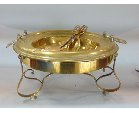 A 19th century brass brazier of circular form with axe head shaped handles raised on a European scrolled base, with further f