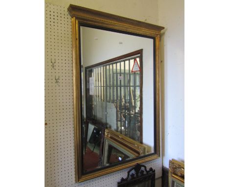 A contemporary reproduction Regency style gilt framed wall mirror of rectangular form with bevelled edge plate, reeded slip a