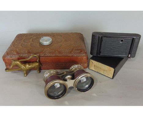 A carved hardwood box with repeating geometric detail, a pair of opera glasses and a Kodac pocket camera model B, complete wi