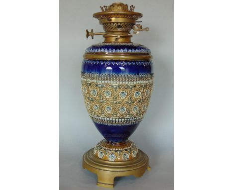 A Doulton Lambeth incised oil lamp case, with glass font, and duplex burner and wick 