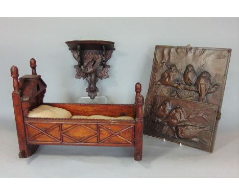 A 19th century carved pine dolls cradle of traditional form with applied detail, 35cm long, small 19th century timber bracket