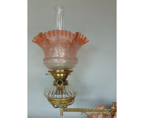 A Victorian oil lamp brass wall bracket, the bracket in the gothic style, the cut glass font with Messenger burner, the shade