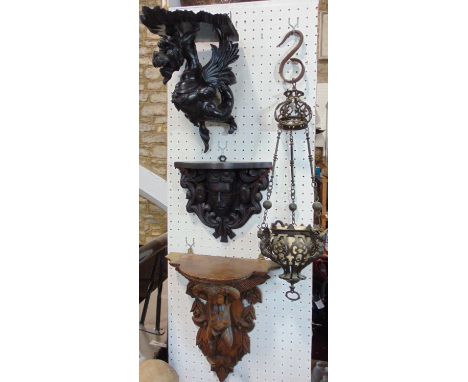 A carved timber bracket in the form of a grotesque winged dragon supporting a shaped shelf, further 19th century bracket with