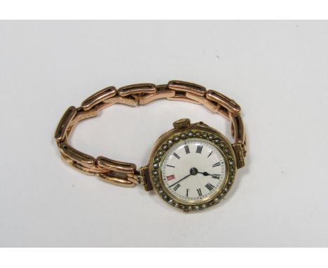 Good quality Swiss 9ct ladies dress watch with seed pearl set bezel, enamel dial with Roman numerals, 27mm case, currently ru