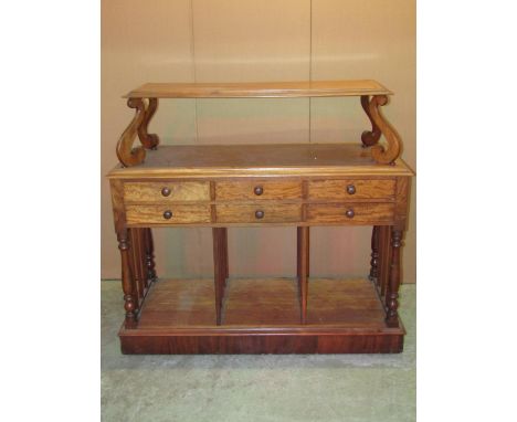 A mid 19th century folio stand, the lower section with three divisions, with six drawers, together with a raised shelf on S s