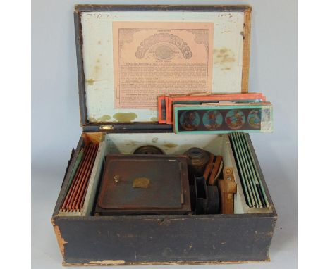 19th century German tin magic lantern, paraffin powered, together with a series of coloured slides (children's model in origi