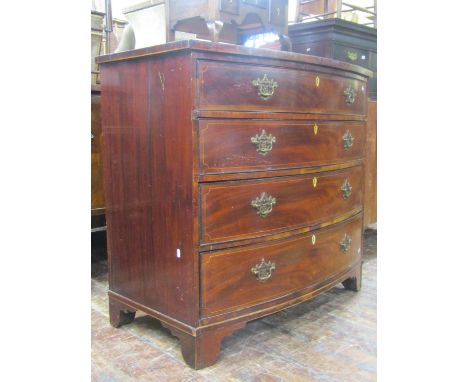 Regency mahogany bow fronted chest of four long graduated drawers with crossbanded finish with brass handles on bracket suppo