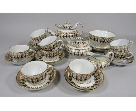 A collection of early 19th century teawares with blue and gilt lozenge and foliate border decoration comprising teapot and st