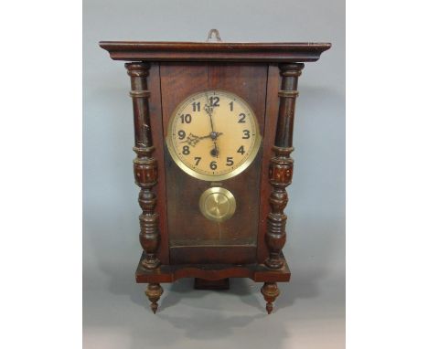 A German wall clock the case with split spindle mouldings incorporating an eight day time piece 