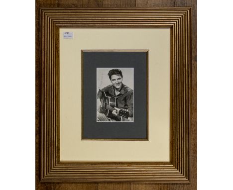 Elvis Presley (1935-1977). Autograph on publicity postcard, c. 1960s, the photographic portrait signed in pale blue ink, 14 x