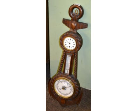 An oak naval themed aneroid barometer, combined with a thermometer box and time piece 