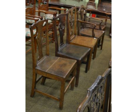 Five various George III oak chairs comprising three plank seated examples, each with yoke crest rails, a commode and a corner