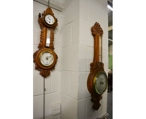 A carved oak aneroid barometer combined with a thermometer box and timepiece, and another carved oak aneroid barometer 
