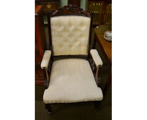 An early 20th century beech open armchair, button back, padded arms, carved details, cabriole legs to castors