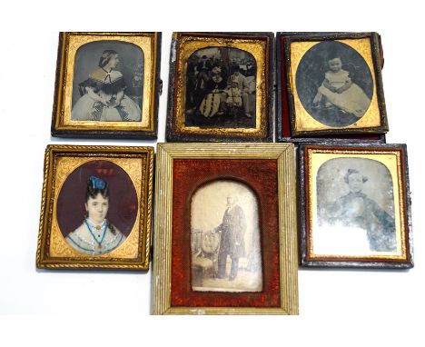 A Victorian watercolour miniature of a lady in a white dress, 6cm x 7cm, and four Victorian portrait photographs, including a