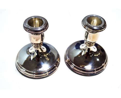 A pair of silver modern short round candlesticks by R Carrs, hallmarked for Sheffield 2005, 10.5cm high x 9cm diameter, un-us